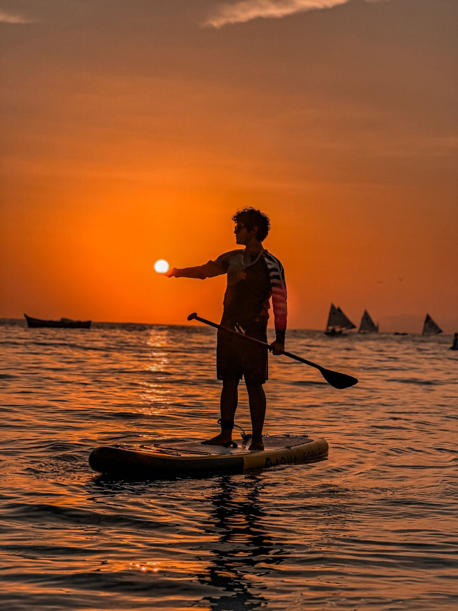 a man on a paddle board with a paddle in the middle of the water